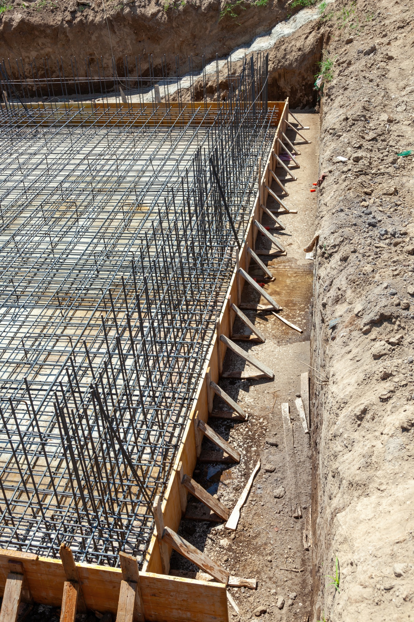 Foundation reinforcement steel bars and wooden formwork preparing for concrete pouring